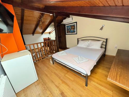a bedroom with a bed in a room with wooden floors at The Sea View kanali in Kanali