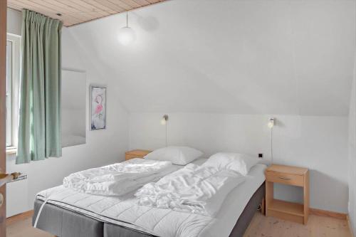a bedroom with a large bed with white sheets at 1311-Stege-Rylevej-20 in Stege