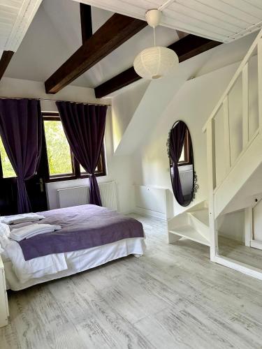 a bedroom with a large bed and purple curtains at MurMur Chalet in Breaza