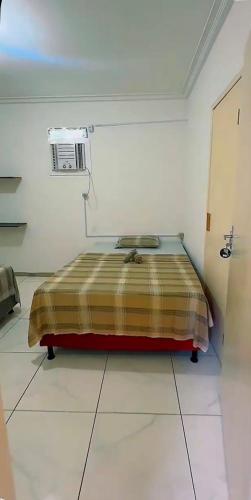 a bedroom with a bed in a white room at SR Hotel e Pousada Pirambu in Pirambu