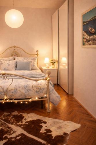 a bedroom with a bed with lights on it at Apartmani Ribarica**** in Karlobag