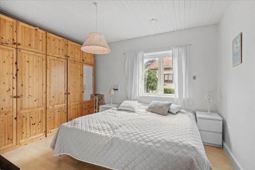 a bedroom with a large bed and a window at 4033-Stege-Kirkebakken-33 in Stege
