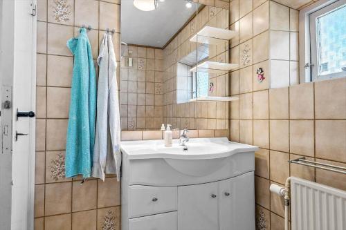 a bathroom with a sink and a mirror at 4019-Stege-Udbyvej-15 in Stege