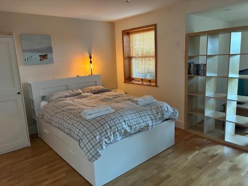 a bedroom with a bed with two towels on it at Retreat in Cardiff