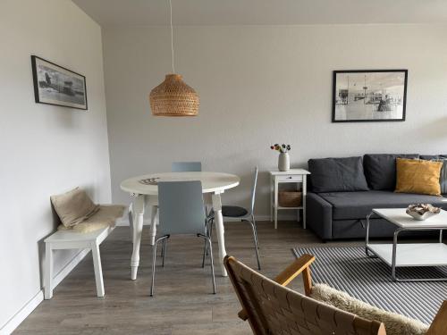 a living room with a couch and a table at Oland Whg 3 Bi de Meere in Wyk auf Föhr