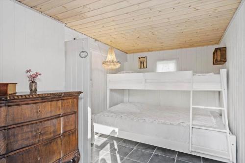 a bedroom with white bunk beds and a wooden ceiling at 8223-Vordingborg-Laekrogen-13 in Vordingborg