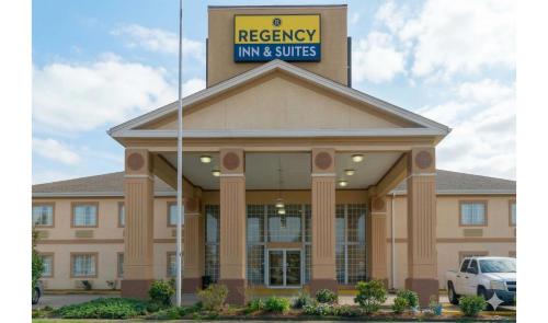 a building with a sign on top of it at Regency Inn & Suites Houston East I 10 in Houston