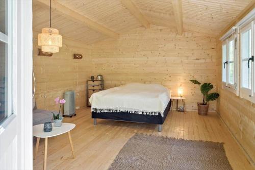 a bedroom with a bed in a wooden room at 2025-Stege-Ulvshalevej-319 in Stege