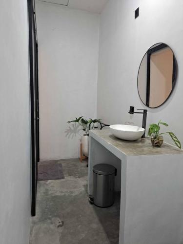 a bathroom with a sink and a mirror on a counter at Second Point View BK in Batukaras