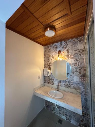 a bathroom with a sink and a mirror at Chalé Vila Catarina in Ouro Preto