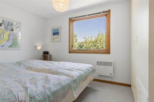 a bedroom with a bed and a window at 3055-Stege-Stejlepladsen-23 in Stege
