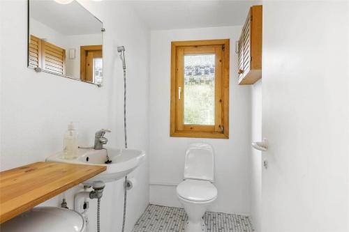 a white bathroom with a sink and a toilet at 3055-Stege-Stejlepladsen-23 in Stege