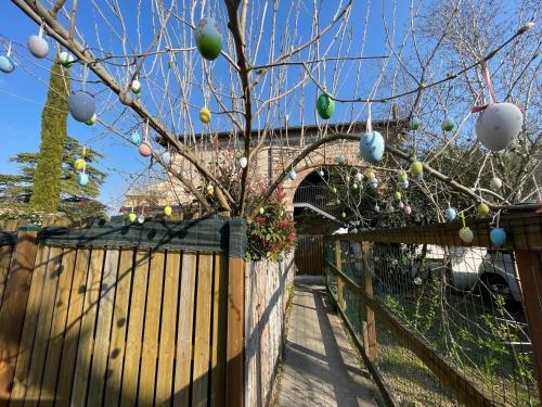 a tree with christmas ornaments hanging from a fence at Il Nido della Buonanotte 2 KIDS friendly in Verona