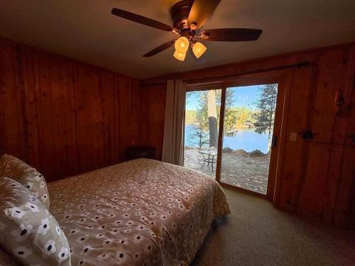 a bedroom with a bed and a ceiling fan at Hilltop - Bouchard Shores Resort in Minocqua
