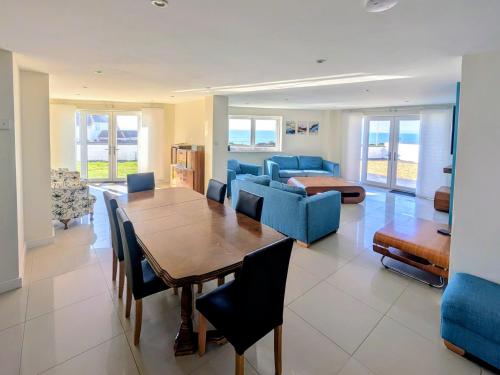a living room with a wooden table and blue chairs at Bournemouth Beach & Sea Views in Bournemouth
