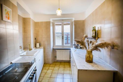 a kitchen with a counter and a sink and a window at Casa Caramello in Faggeto Lario 