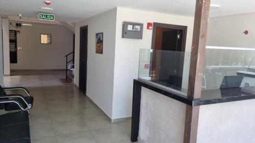 a lobby with a glass counter in a building at Hotel Recife in Ciudad del Este