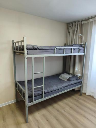 two bunk beds are in a room with a floor at Tara Guesthouse and Tours in Ulaanbaatar