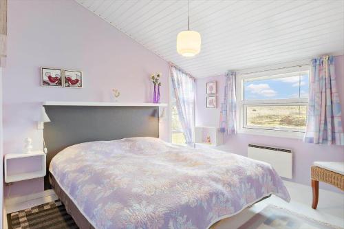 a bedroom with a large bed and a window at HA344-Saeby-Annesvej-1 in Sæby