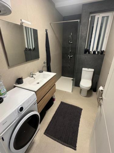 a bathroom with a sink and a washing machine at Ta' Cenc Residence Block C, Apt 4 in Sannat