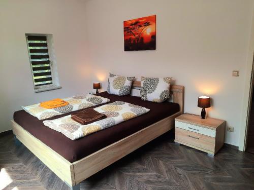 a bedroom with a bed and a night stand at Ferienwohnung Berthold WG 6 in Blankenburg