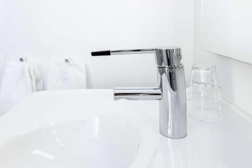 Un lavabo de baño con grifo cromado en Scandic Stiklestad, en Verdal