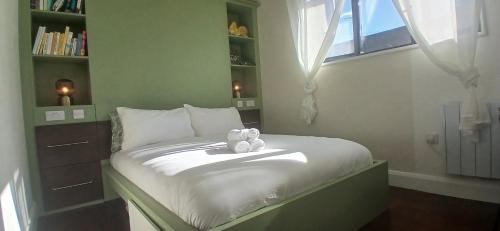a small bedroom with a bed with two teddy bears on it at Stylish Cottage with Loft Sleeps 4 in Dublin