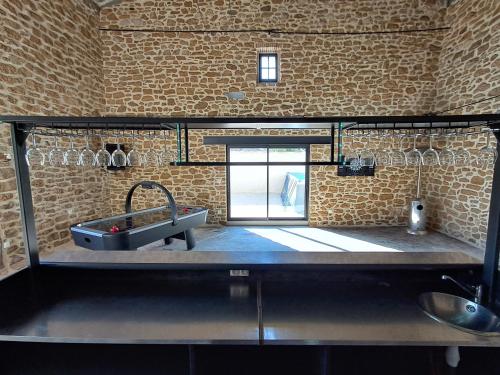 a kitchen with a sink and a tub in a room at Chez Véro Gîte & Chambres d'hôtes " Le Juvaquatre " in Suze-la-Rousse