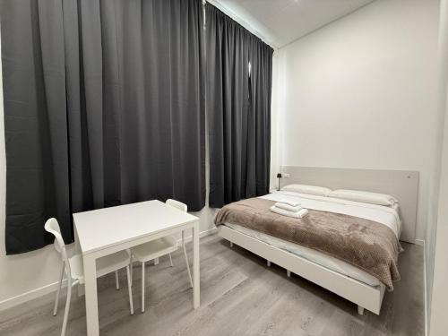 a bedroom with a bed and a desk and a table at Viva Residence in Calderara di Reno