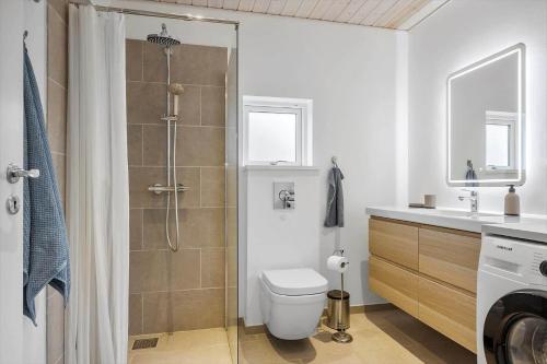 a bathroom with a shower and a toilet and a sink at OH532-Hadsund-Avaenget-14 in Hadsund