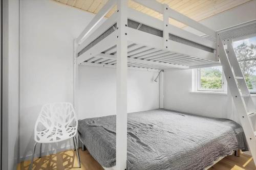 a bedroom with a white bunk bed and a chair at OH532-Hadsund-Avaenget-14 in Hadsund