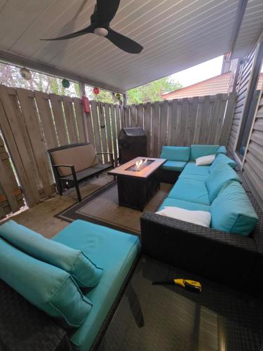 a screened in porch with a couch and a table at Modern Retro 2BR Condo in High Point