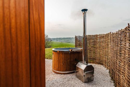 a hot tub and a television sitting next to a fence at Shepherds View in Ashbourne