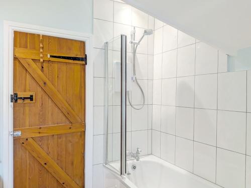 a bathroom with a shower and a bath tub at Vane Cottage - Lewes in Lewes