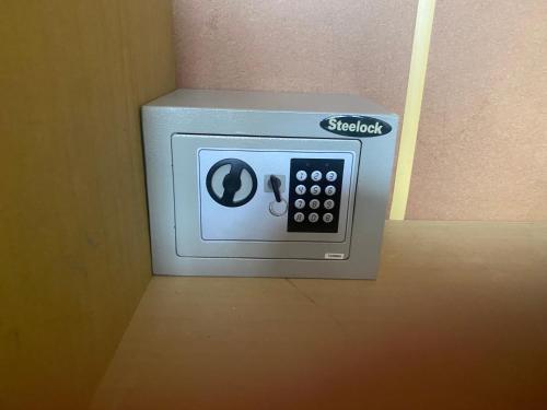 a safe in a hotel room with a remote control at CHALET CHAPITAL Punta Arenas in Punta Arenas