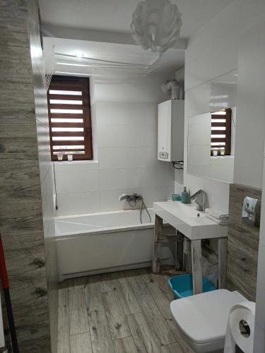 a bathroom with a tub and a sink and a toilet at 3 Rooms Garden Parking in Raszyn