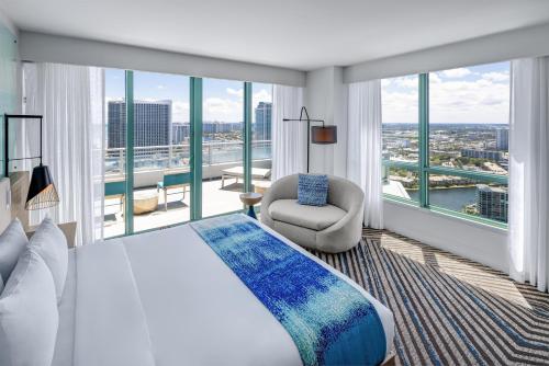 a bedroom with a bed and a large window at The Diplomat Beach Resort Hollywood, Curio Collection by Hilton in Hollywood