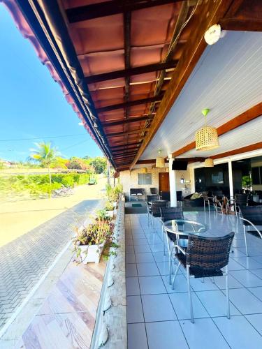 a patio with chairs and tables on a building at Pousada São Silmares in Fernando de Noronha