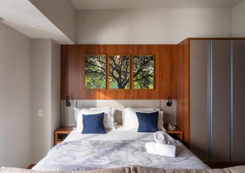 a bedroom with a large bed with two windows at Tropical executive vista Rio in Manaus