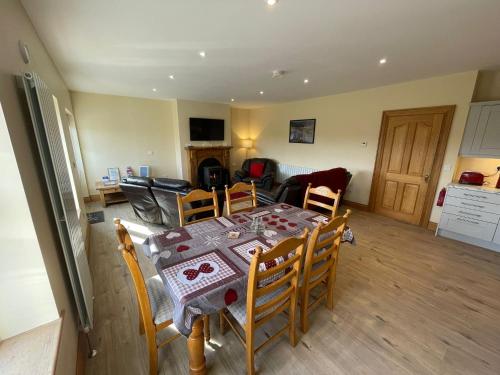 a dining room and kitchen with a table and chairs at Molly's Self Catering Accommodation in Cavan
