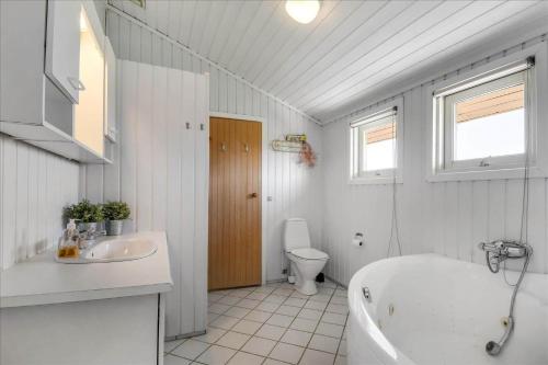 a bathroom with a tub and a sink and a toilet at G195-Lemvig-Porsevej-95 in Lemvig