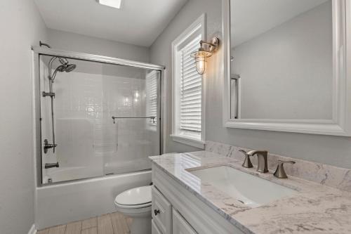ein Badezimmer mit Waschbecken, Dusche und Toilette in der Unterkunft Sounds About Wright OBX in Kill Devil Hills