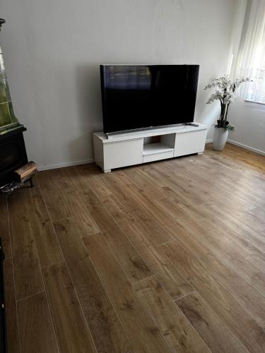 a living room with a flat screen tv on a white cabinet at Karla in Torgelow