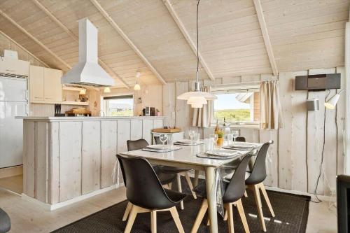 a dining room and kitchen with a table and chairs at 511-Lemvig-Lyngsletten-13 in Lemvig