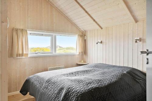 a bedroom with a bed and a window at 511-Lemvig-Lyngsletten-13 in Lemvig