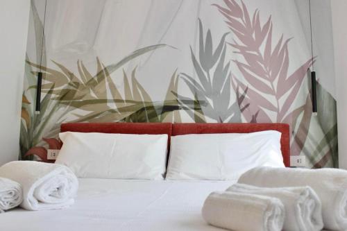 a bedroom with a bed with towels on it at MB House in Sistiana