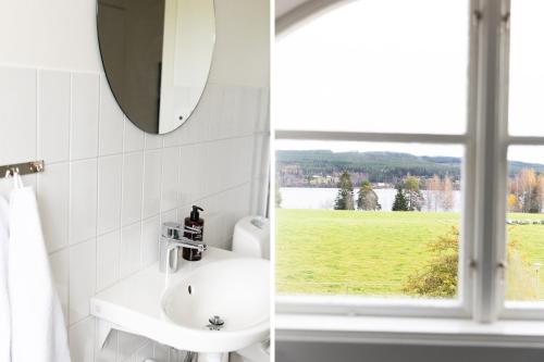 a bathroom with a sink and a window at STF Undersvik Gårdshotell in Vallsta