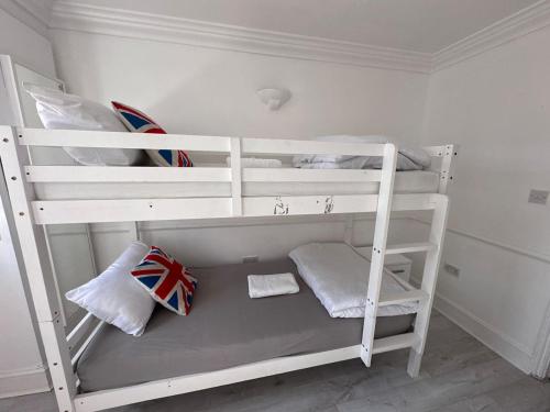 a white bunk bed in a white room at Stay in Brick Lane in London