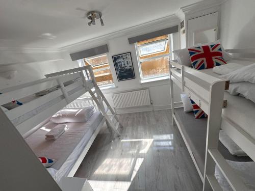 a small room with two bunk beds and a ladder at Stay in Brick Lane in London