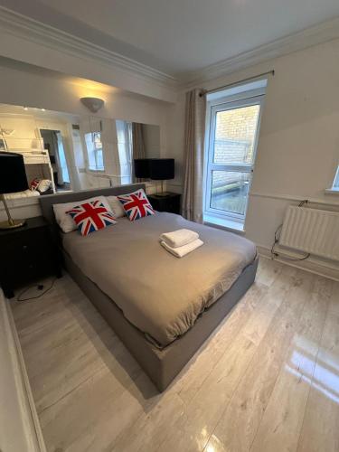 a bedroom with a bed with two pillows on it at Stay in Brick Lane in London